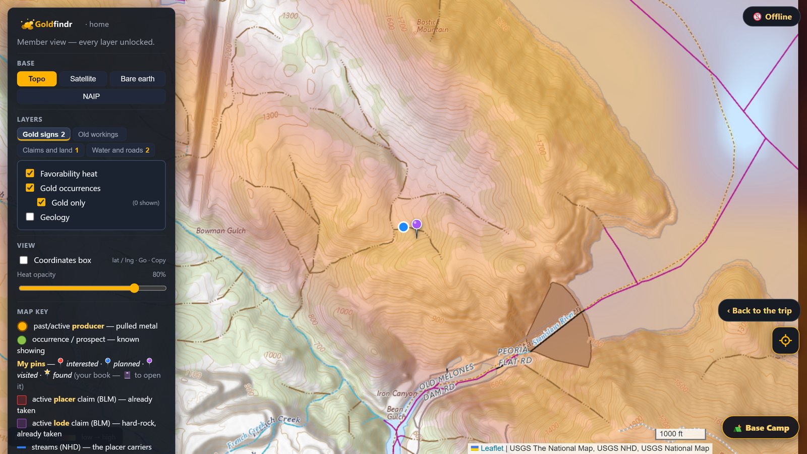 The map in airplane mode, drawn from the pack with the gold heat on, the blue GPS dot beside a visited pin, the Offline chip