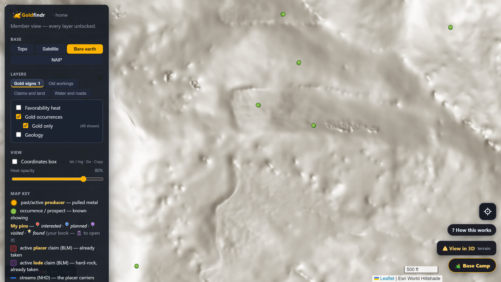 Bare-earth close-up: a benched cut and rows of old prospect pits in the terrain