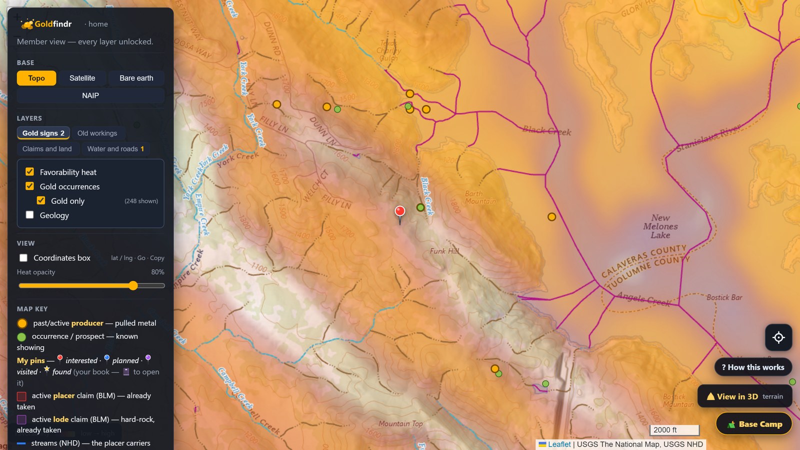 The same creek bend with a fresh red pin standing on the ground